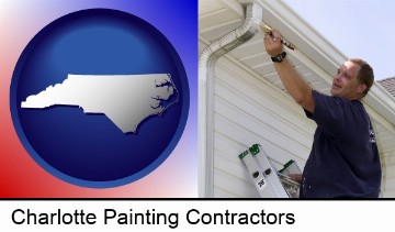 a painting contractor brushing paint on an aluminum leader in Charlotte, NC