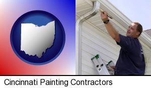 Cincinnati, Ohio - a painting contractor brushing paint on an aluminum leader
