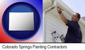 a painting contractor brushing paint on an aluminum leader in Colorado Springs, CO