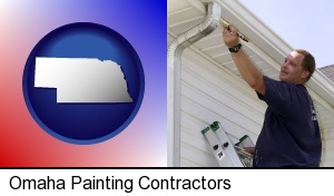 Omaha, Nebraska - a painting contractor brushing paint on an aluminum leader