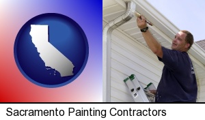 Sacramento, California - a painting contractor brushing paint on an aluminum leader