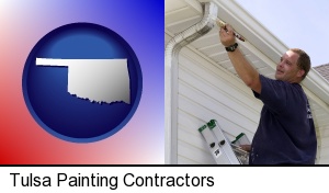 Tulsa, Oklahoma - a painting contractor brushing paint on an aluminum leader