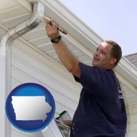 iowa map icon and a painting contractor brushing paint on an aluminum leader