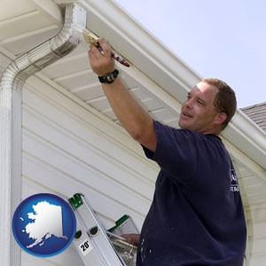 a painting contractor brushing paint on an aluminum leader - with Alaska icon