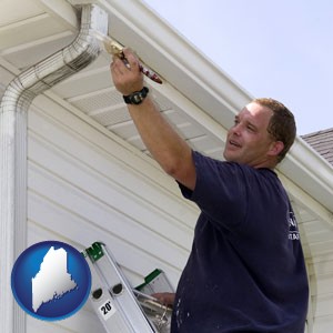 a painting contractor brushing paint on an aluminum leader - with Maine icon