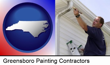a painting contractor brushing paint on an aluminum leader in Greensboro, NC