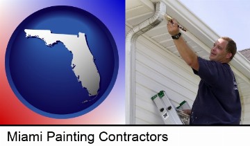 a painting contractor brushing paint on an aluminum leader in Miami, FL