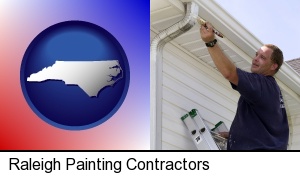 Raleigh, North Carolina - a painting contractor brushing paint on an aluminum leader