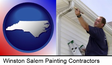 a painting contractor brushing paint on an aluminum leader in Winston Salem, NC